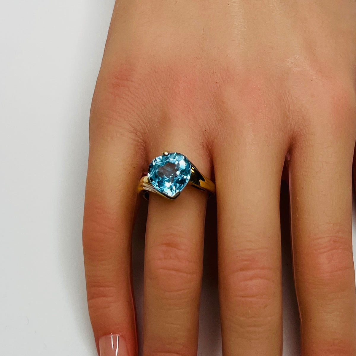 Vintage 10K gold ring with heart-shaped aquamarine gemstone on hand