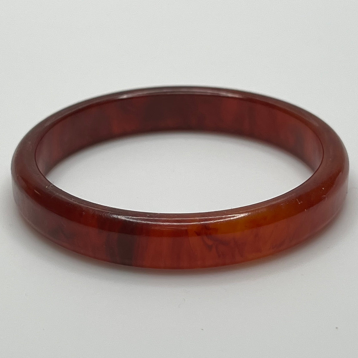 Rounded ½" wide Bakelite bracelet with warm amber swirls
