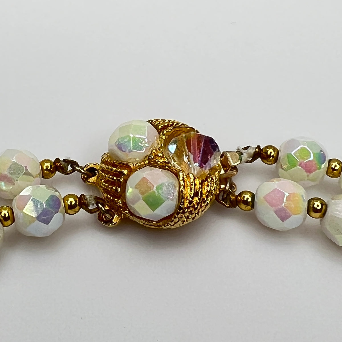 Close-up of ornate goldtone box clasp with coordinating bead accents