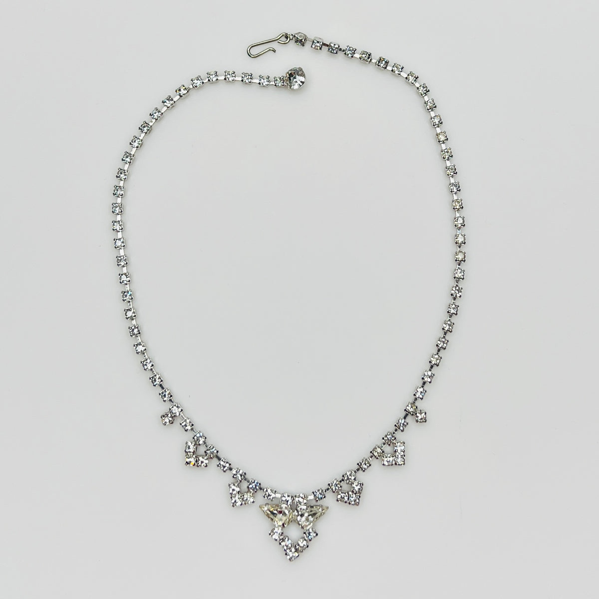 Necklace laid flat showing hook clasp and rhinestone extender