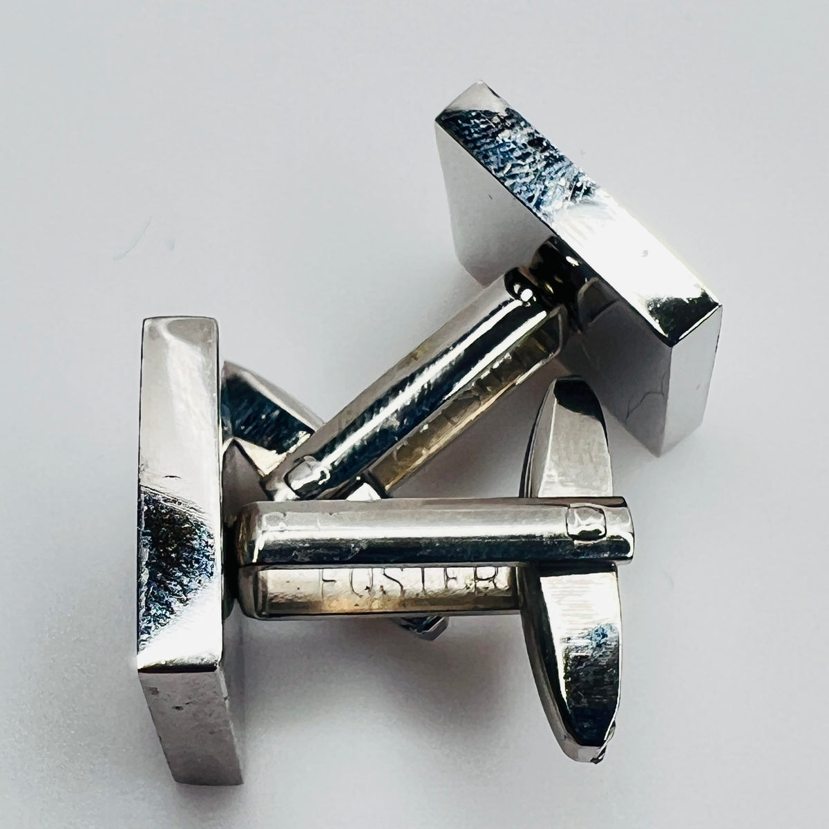 Close-up of cufflink shank marked “Foster”