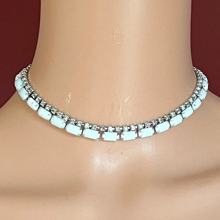 1950s milk glass and rhinestone choker necklace with silver-tone setting and hook closure.