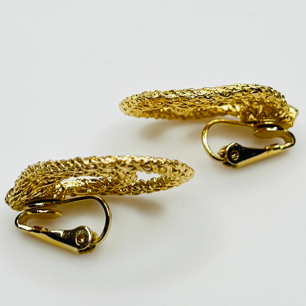 Clip-on earrings with twisted double-loop design