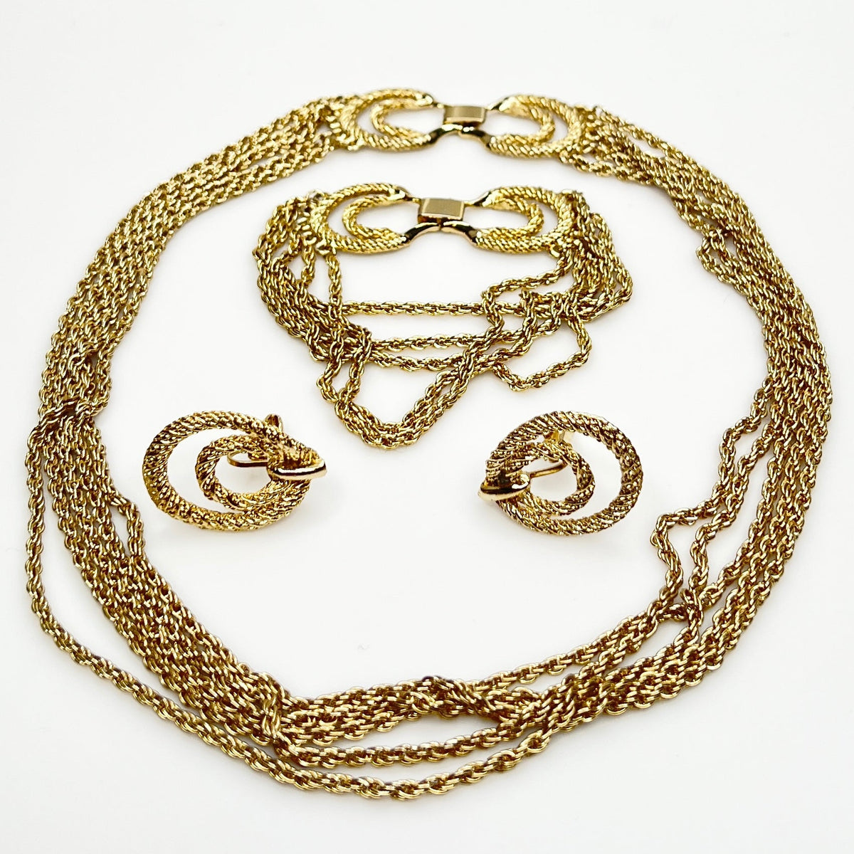Three-piece vintage gold chain jewelry set with necklace, bracelet, and earrings