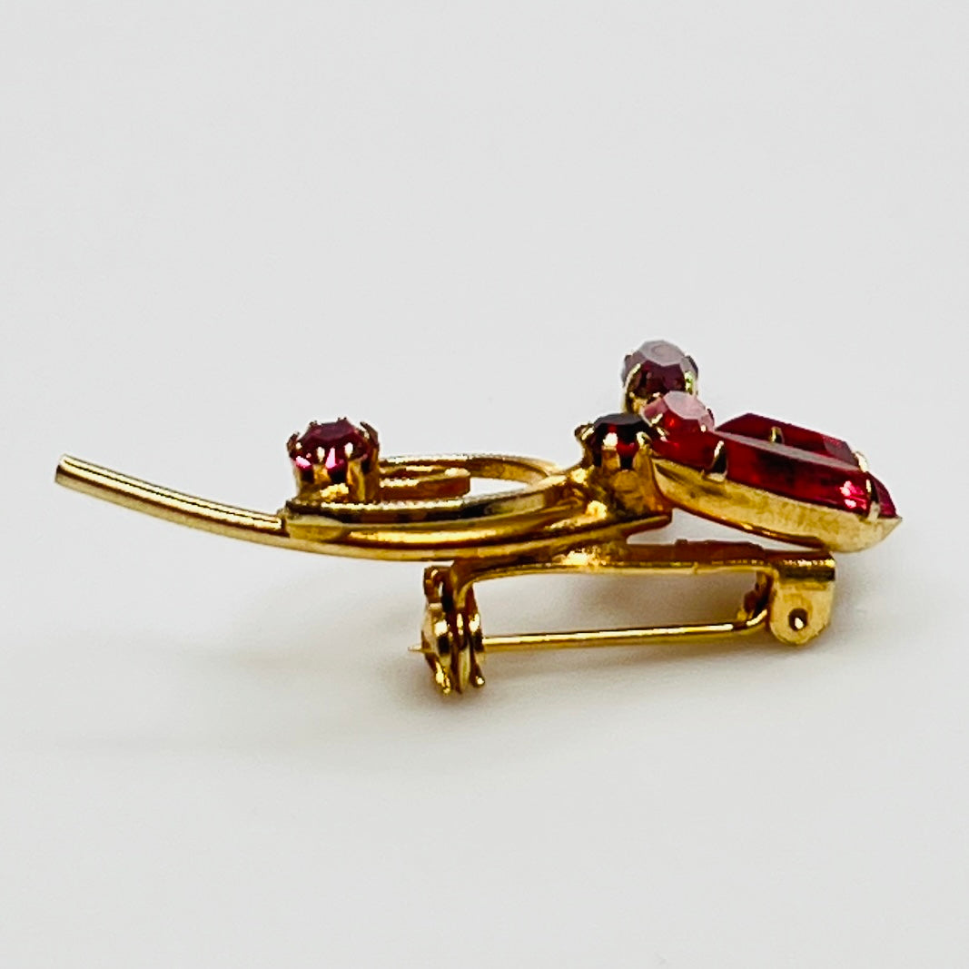 1950s pink rhinestone brooch with gold-tone spiral and navette stones
