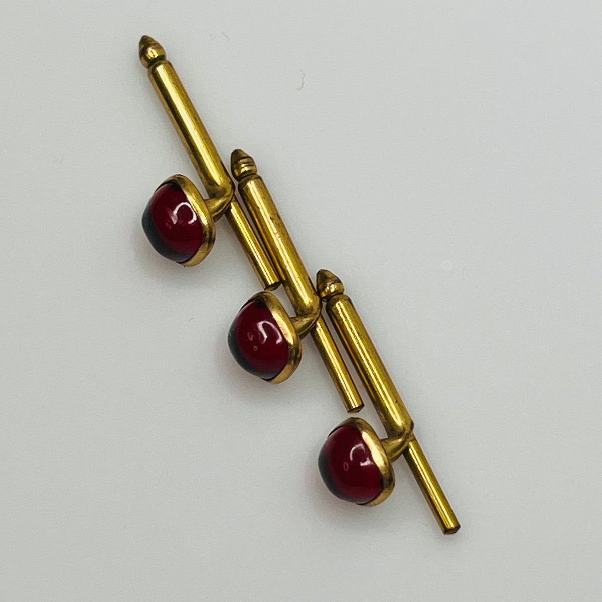 1940s ruby red lucite studs in brass