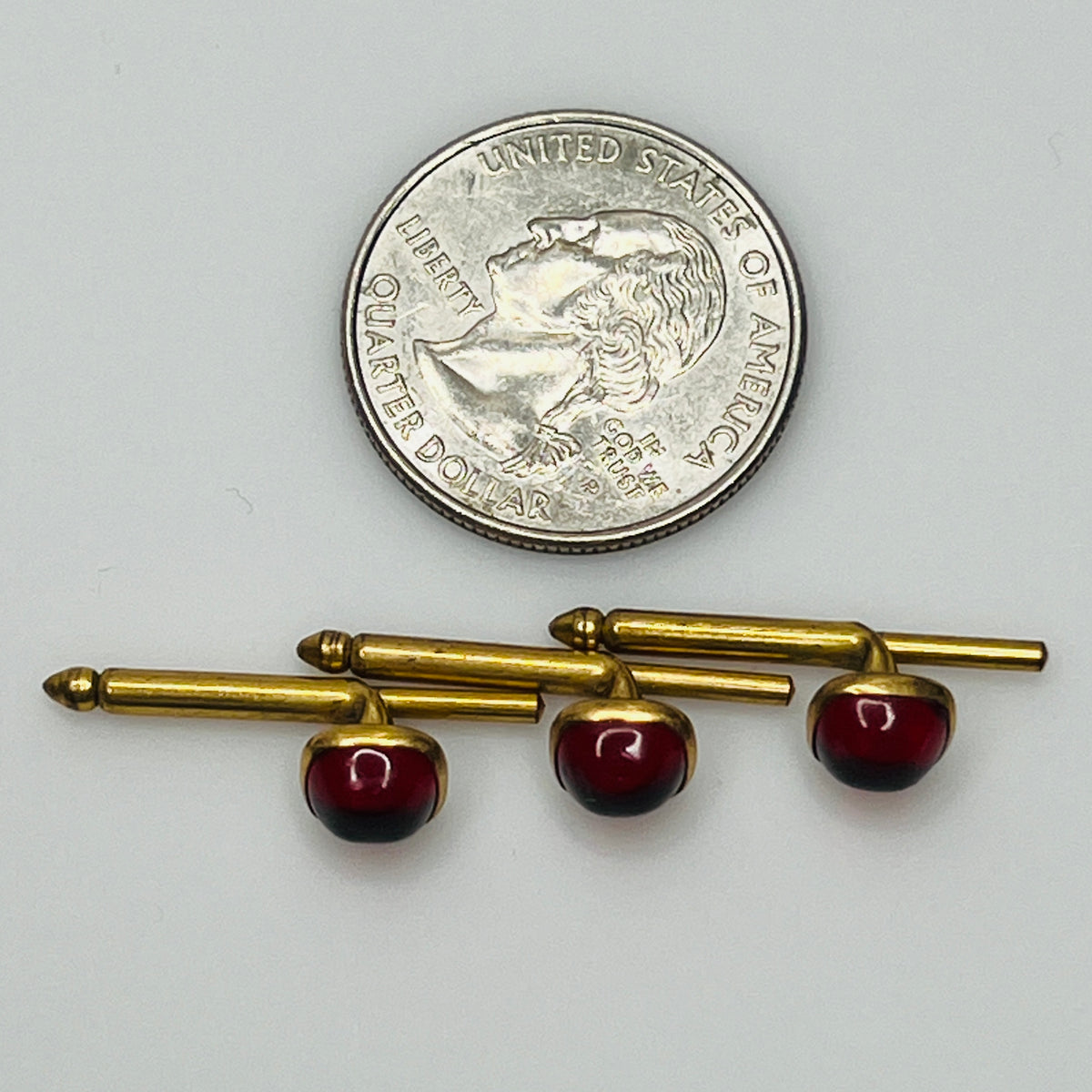 1940s ruby red lucite studs in brass