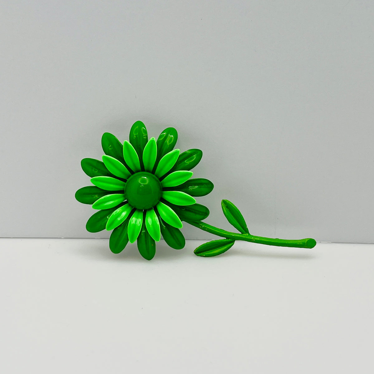 Large green enamel flower brooch with stem and leaves, 1960s