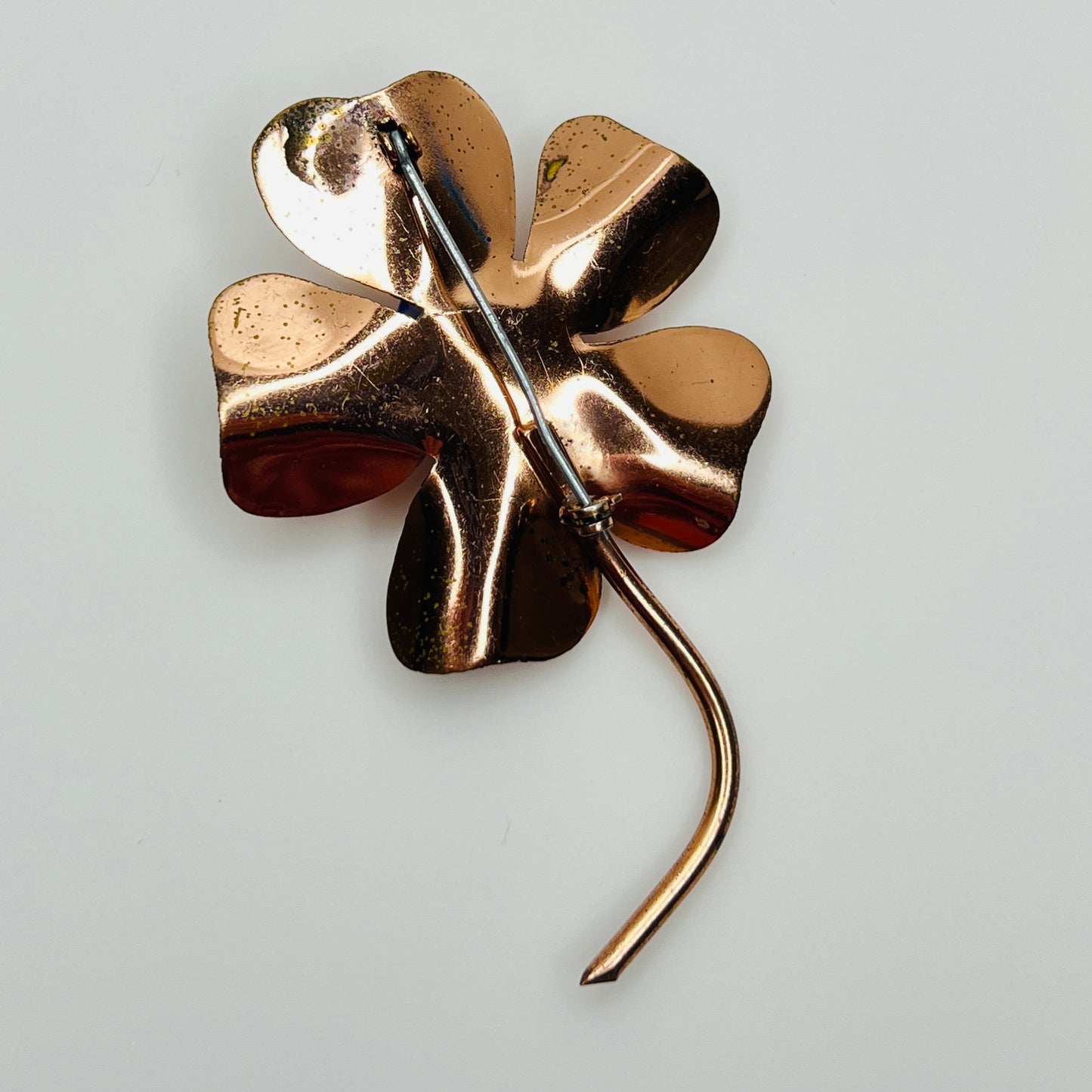 Reverse of brooch showing standard pin and copper finish