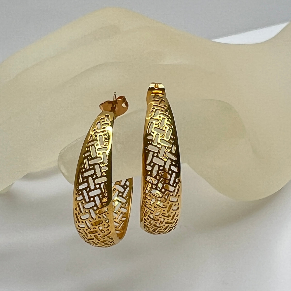 Pair of vintage gold woven statement earrings, close-up