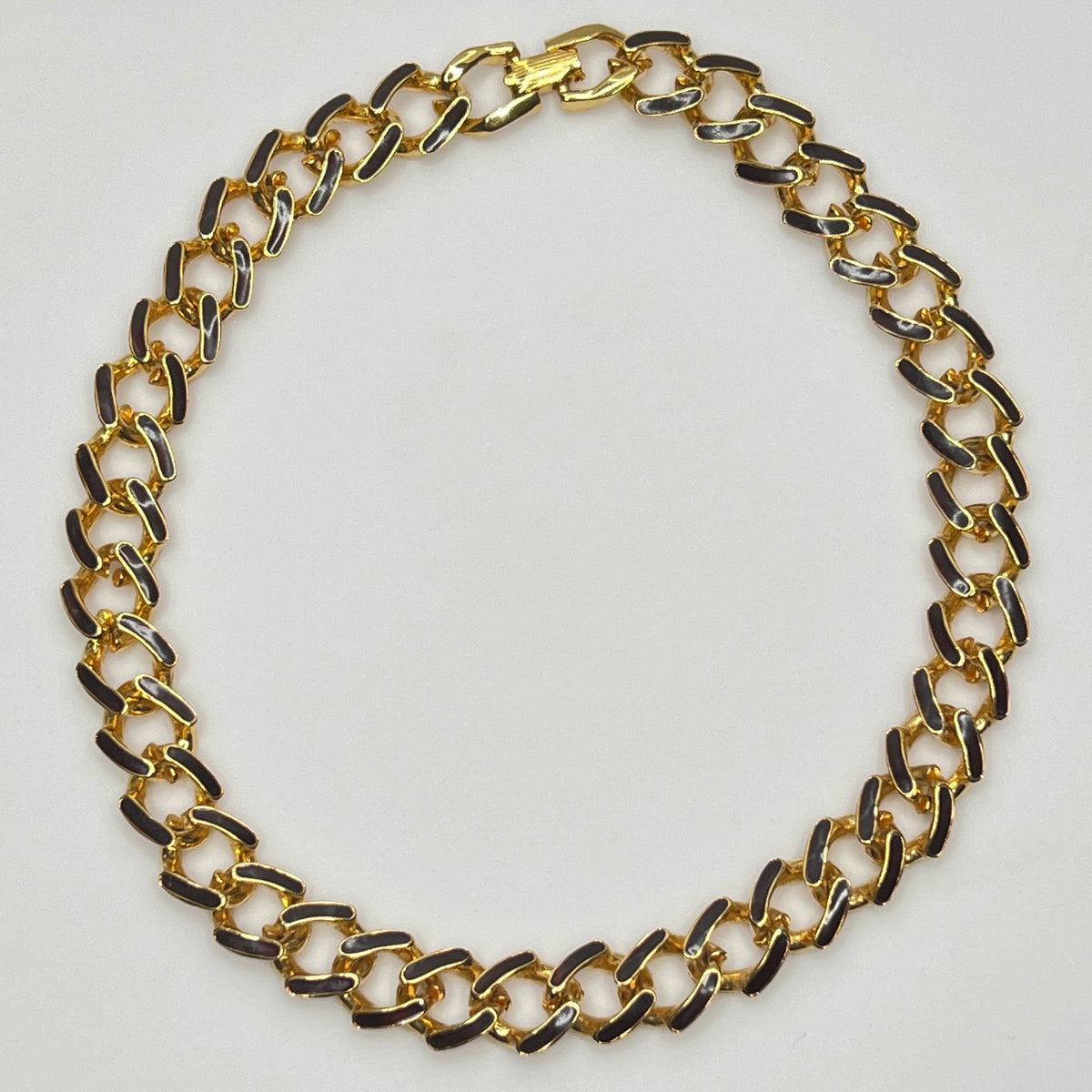 1980s gold-tone chain necklace with brown enamel links and hinge clasp, collar length.