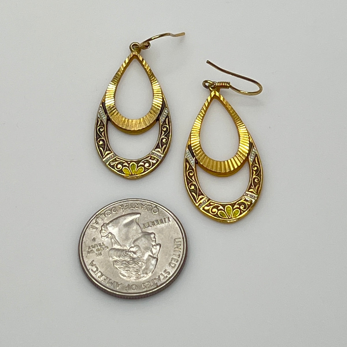 Retro-style open teardrop earrings with yellow, black, and white enamel
