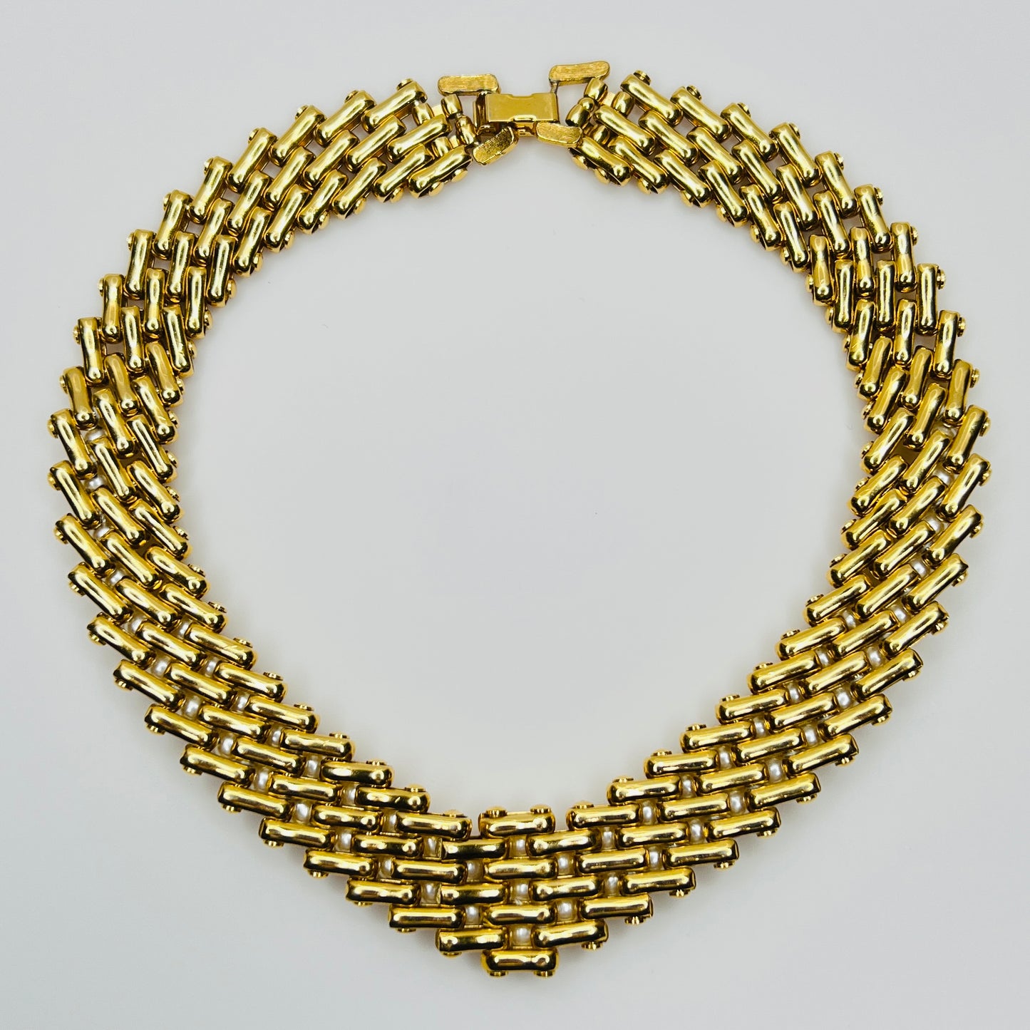 V-shaped gold-tone choker necklace with faux pearls in stacked link design