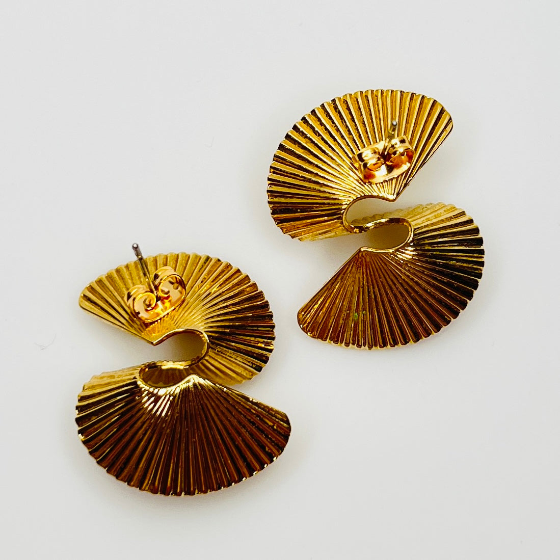 Gold tone sculptural swirl pierced stud earrings