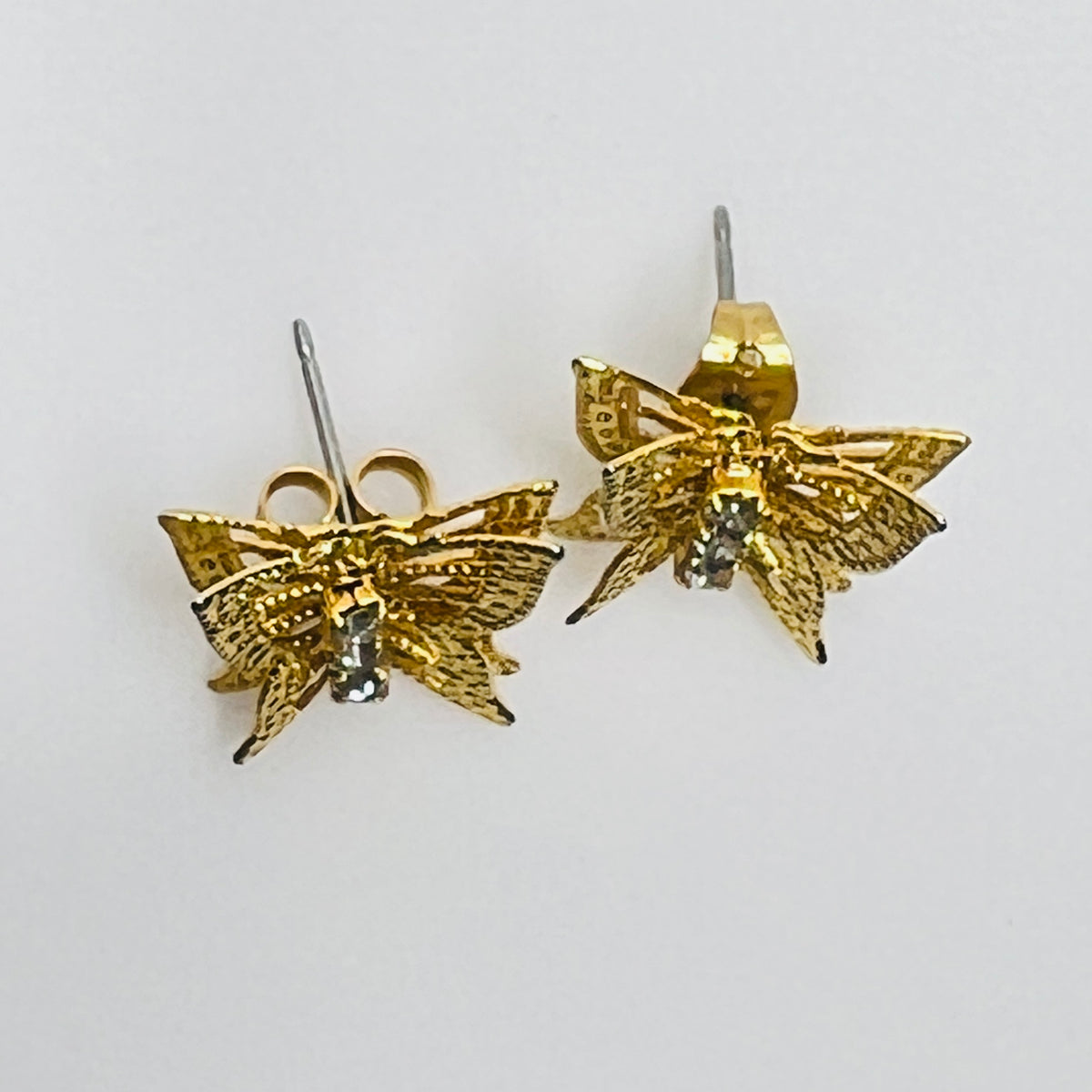 Vintage gold filigree butterfly stud earrings with rhinestone accents