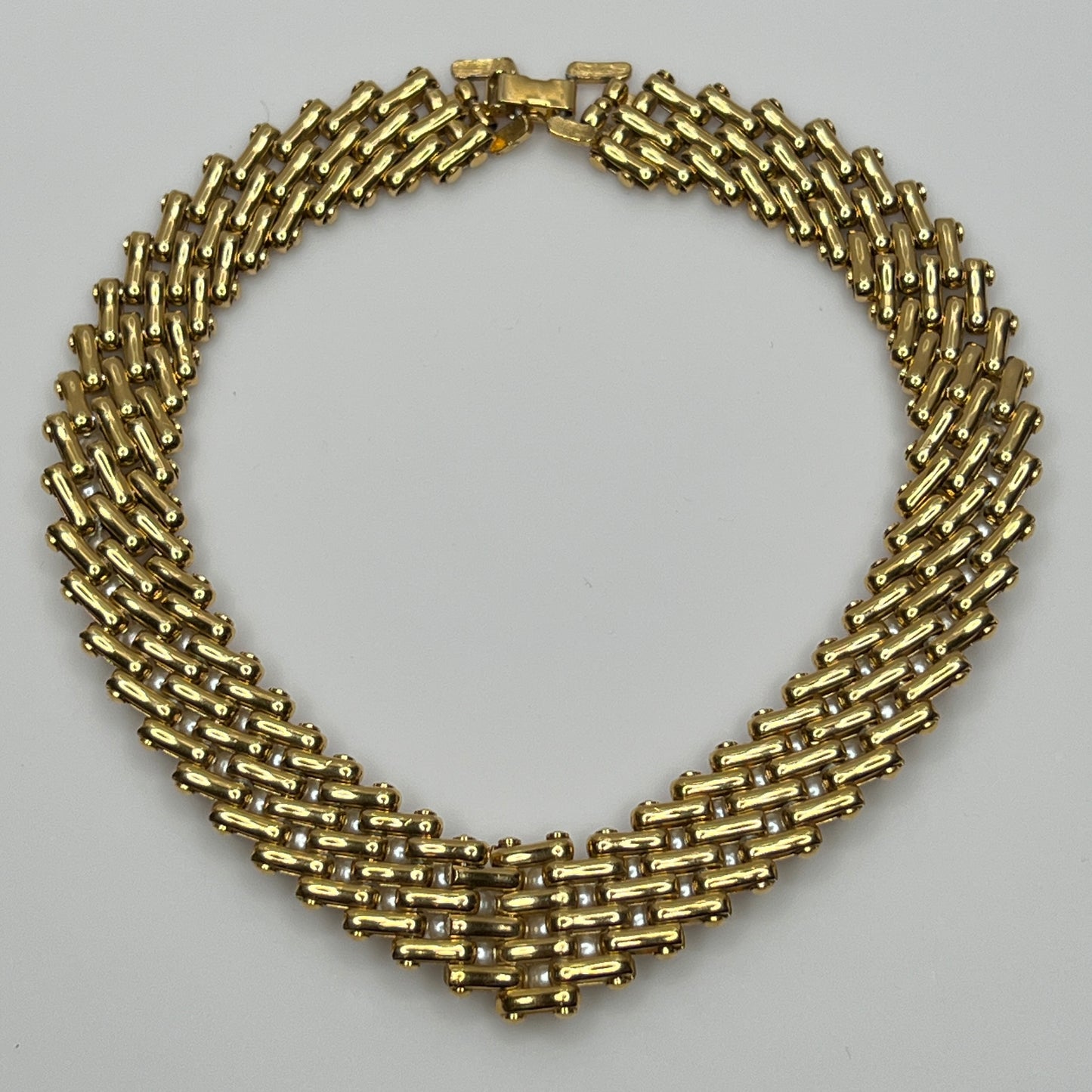 V-shaped gold-tone choker necklace with faux pearls in stacked link design