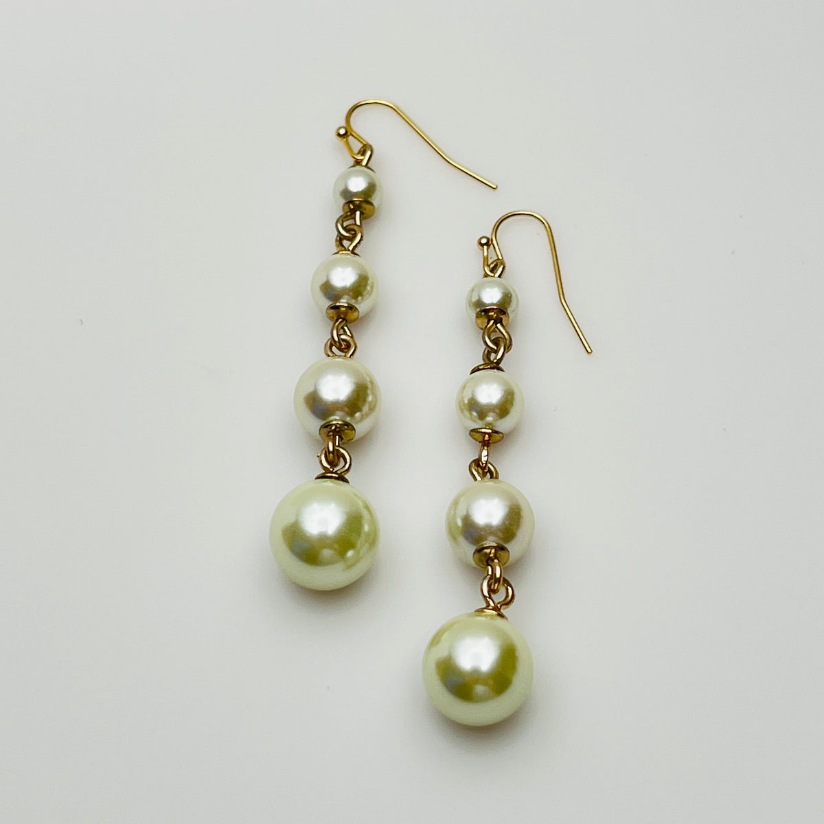 Vintage Lulu Frost long dangle earrings with graduated faux pearls on gold-tone wires