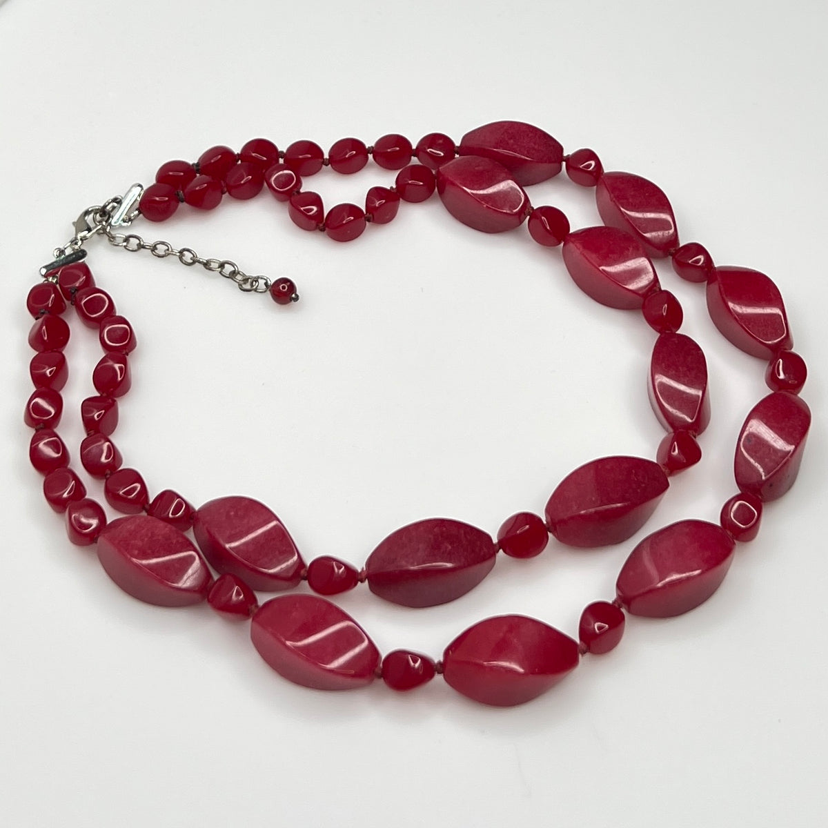 Double strand red bead necklace with large glass ovals and smaller lucite rounds with silver-tone clasp
