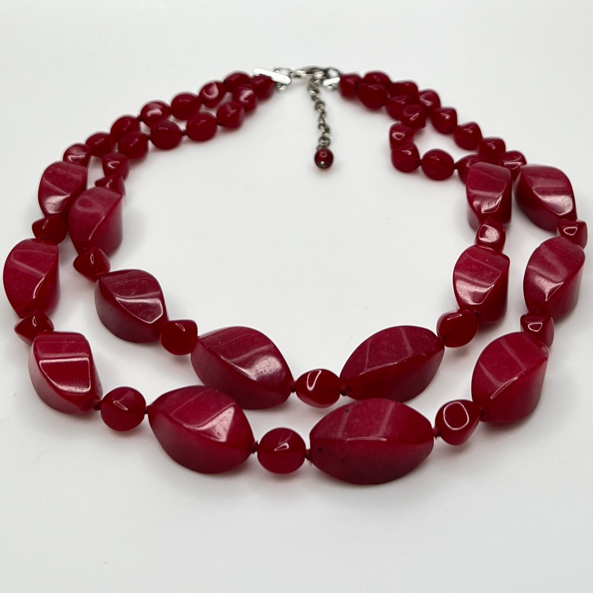 Double strand red bead necklace with large glass ovals and smaller lucite rounds with silver-tone clasp