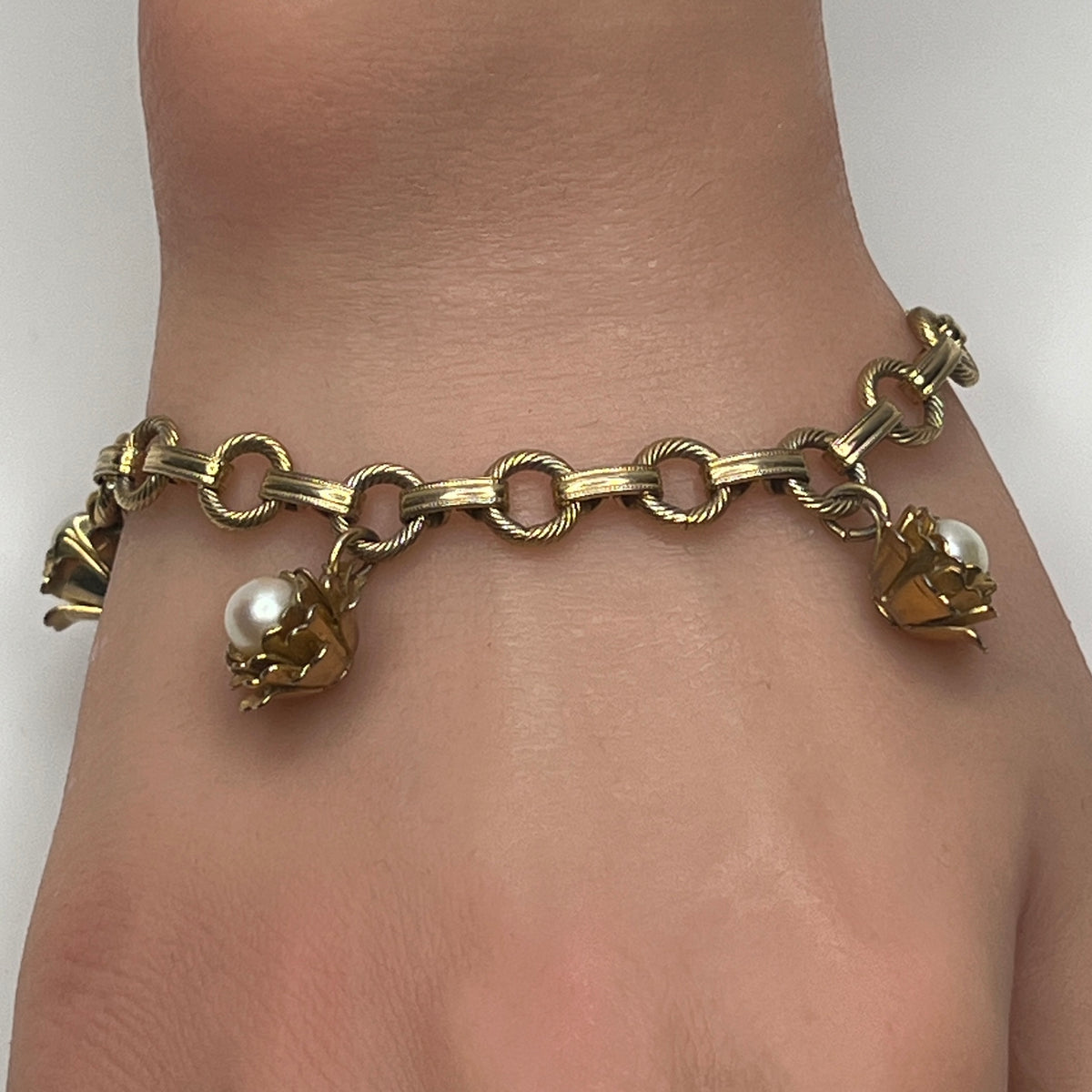 Mid-century gold-tone charm bracelet with faux pearl rosebuds