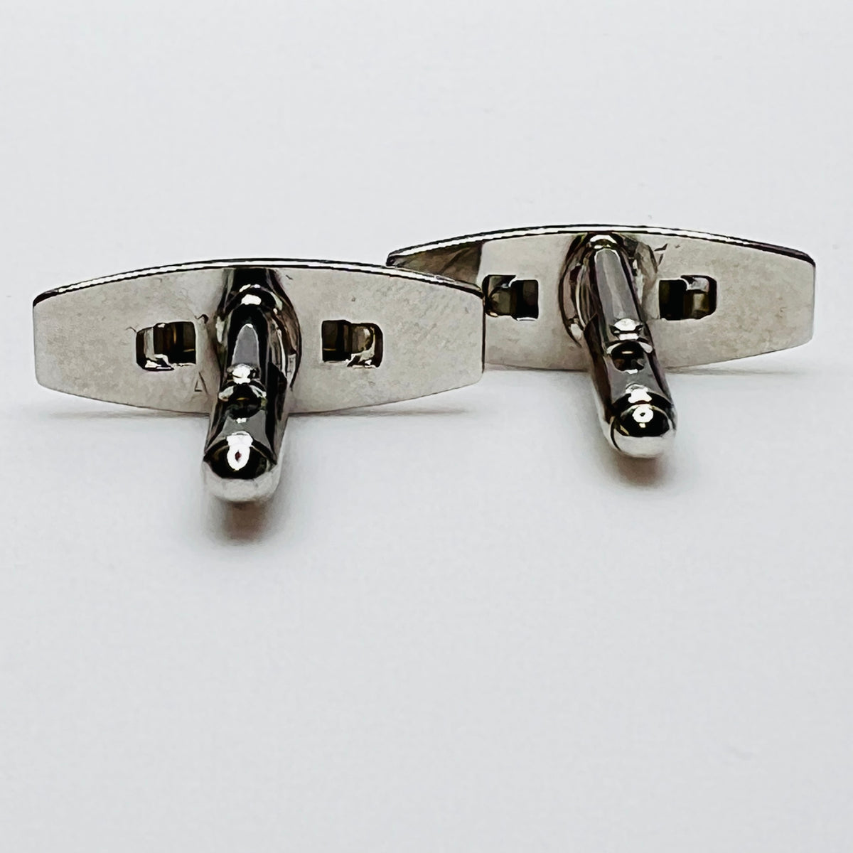 Silver-tone cufflinks with textured finish and vivid blue lucite cabochons, signed Anson