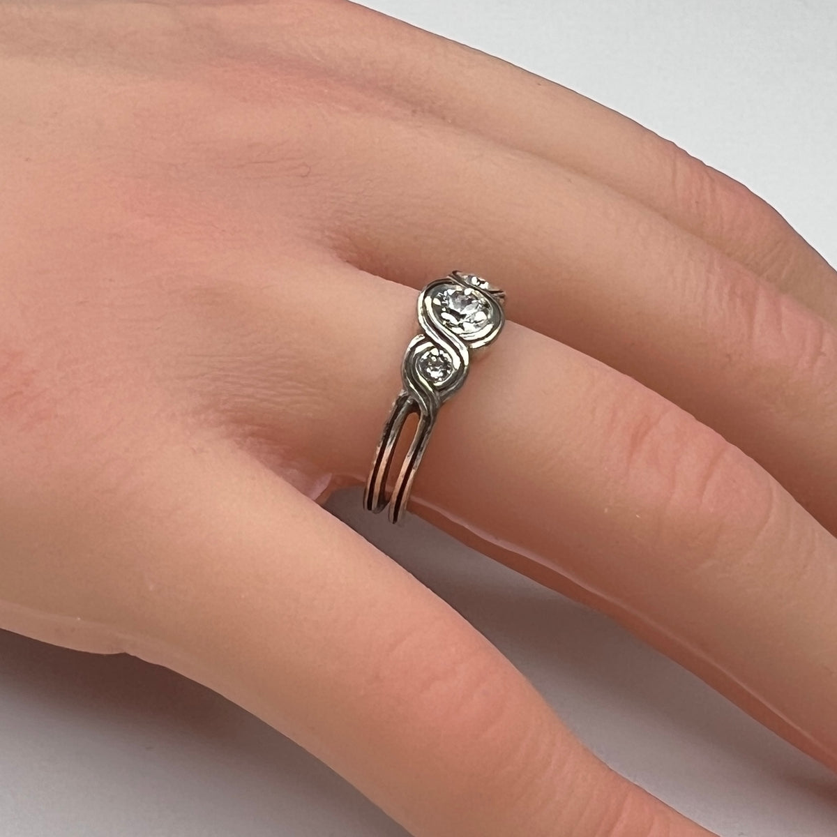 Sterling silver Brighton Infinity ring on hand with three bezel-set crystals