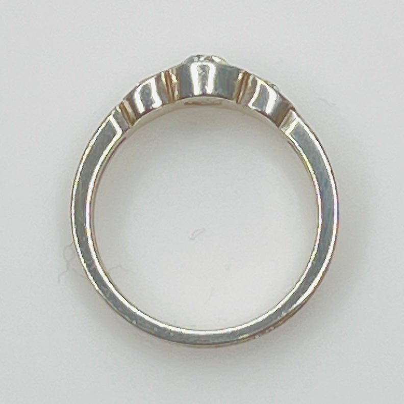 Detailed view of crystal trio wave setting in silver