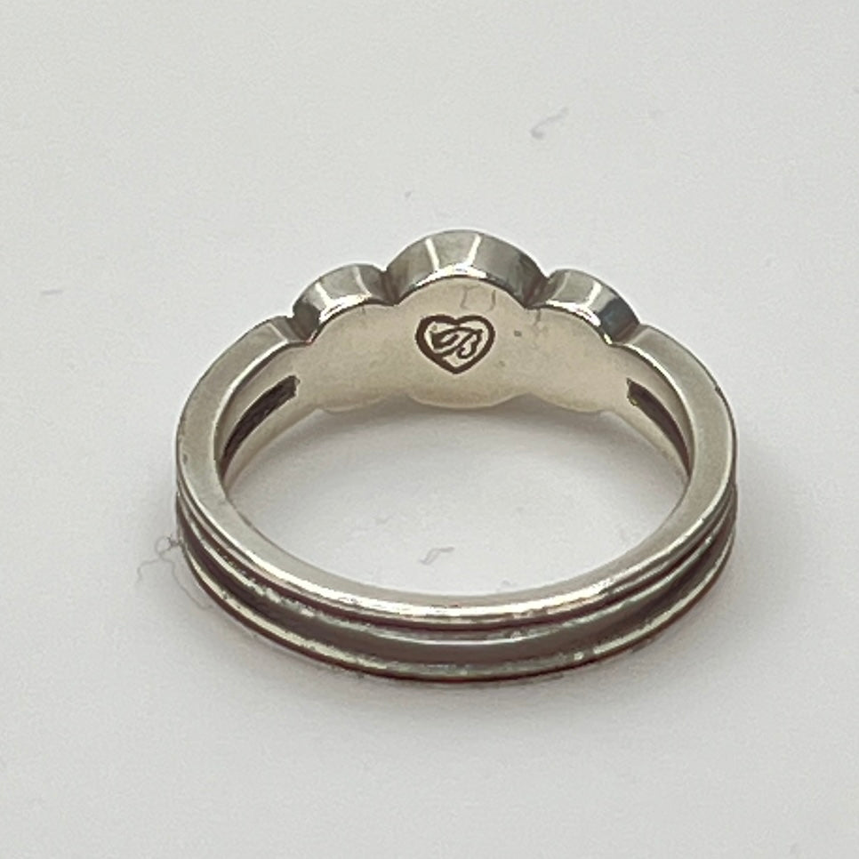 Detailed view of crystal trio wave setting in silver
