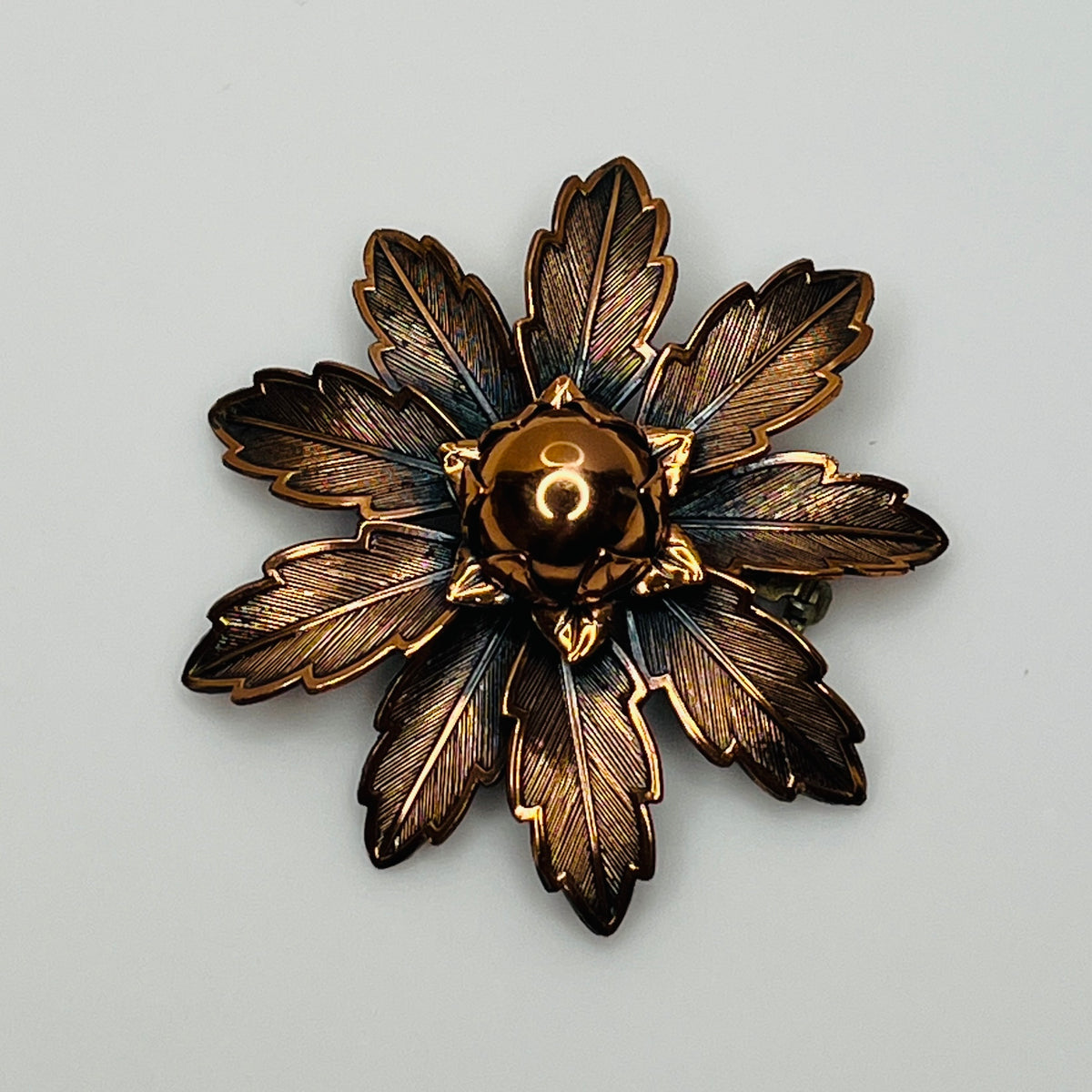 Vintage Copper Bell brooch with leaf motif and domed center flower