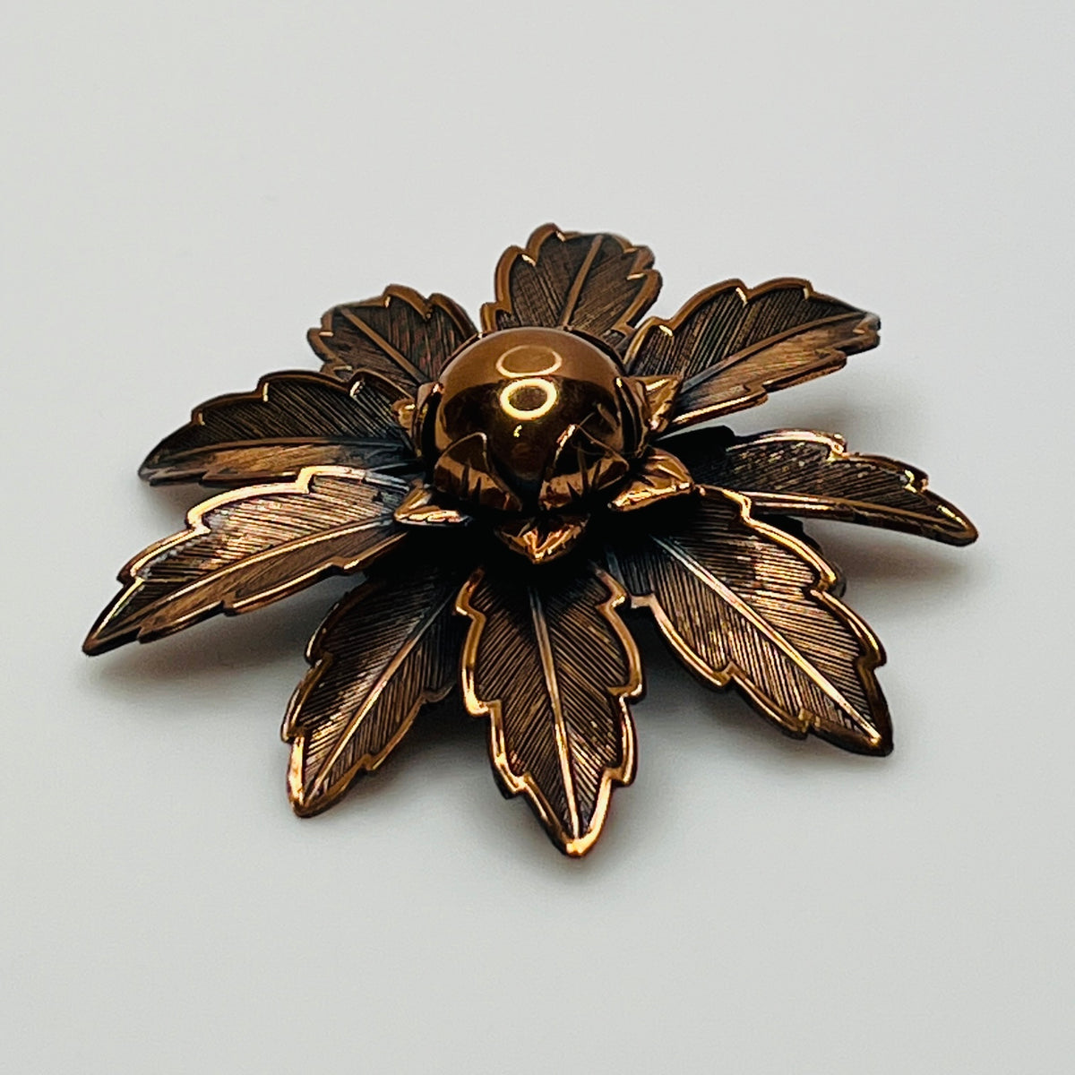 Vintage Copper Bell brooch with leaf motif and domed center flower