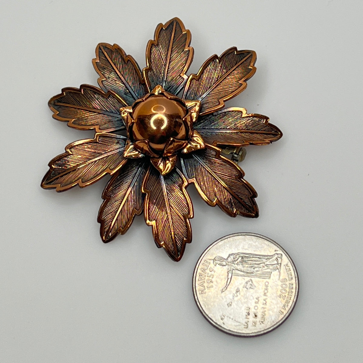 Vintage Copper Bell brooch with leaf motif and domed center flower