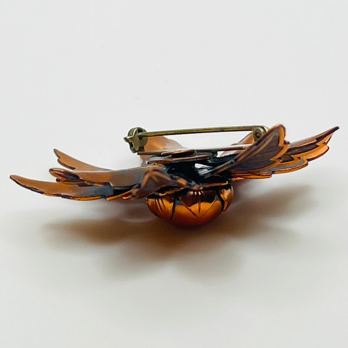 Vintage Copper Bell brooch with leaf motif and domed center flower