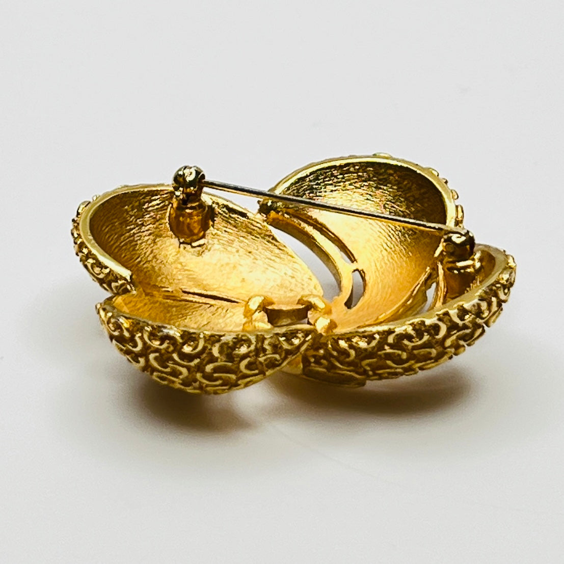 Side angle showing dimensional texture and sculpted swirl detailing