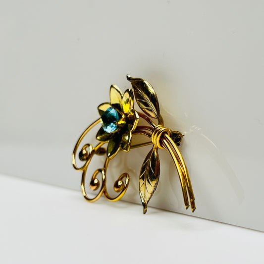 Vintage gold-filled floral brooch with blue rhinestone, signed Harry Iskin