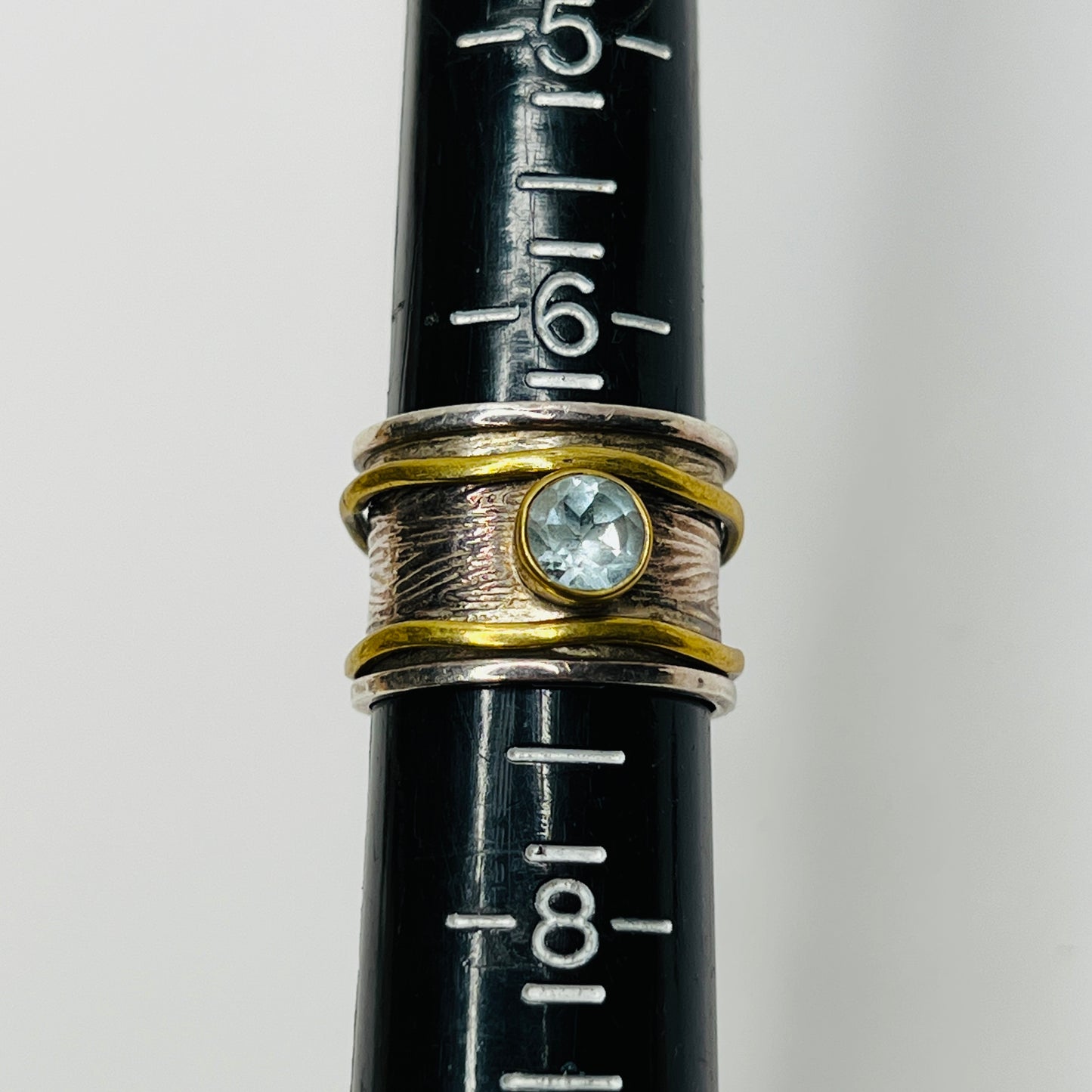 Close-up of vintage fidget worry ring with sapphire and mixed metals