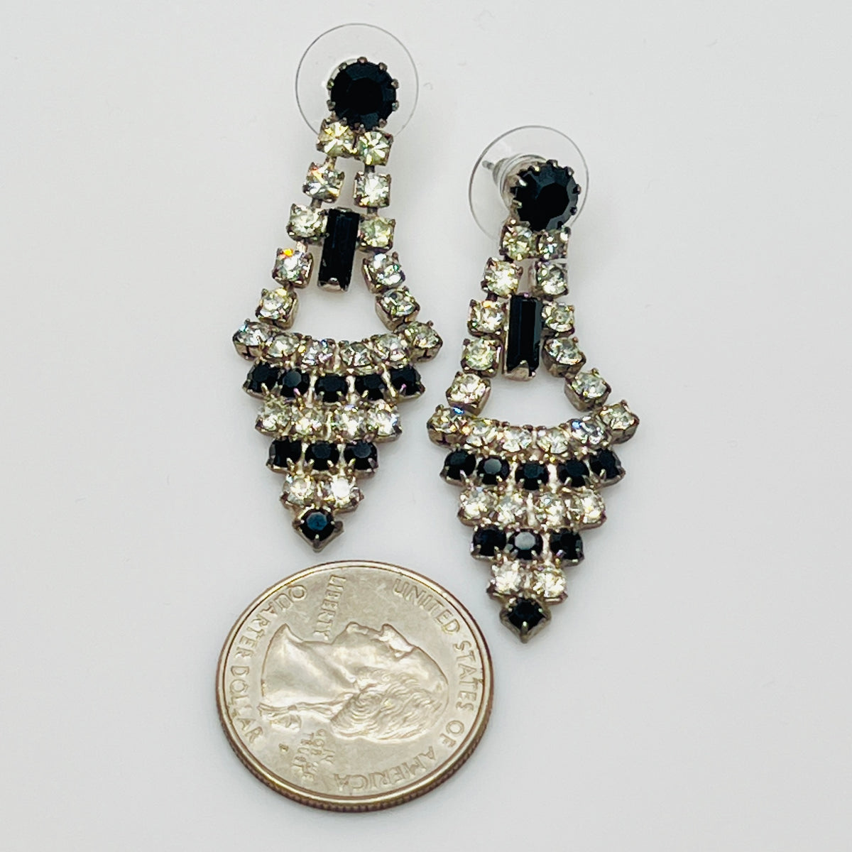 Art Deco-style earrings with black and clear rhinestones in a long silver-tone design
