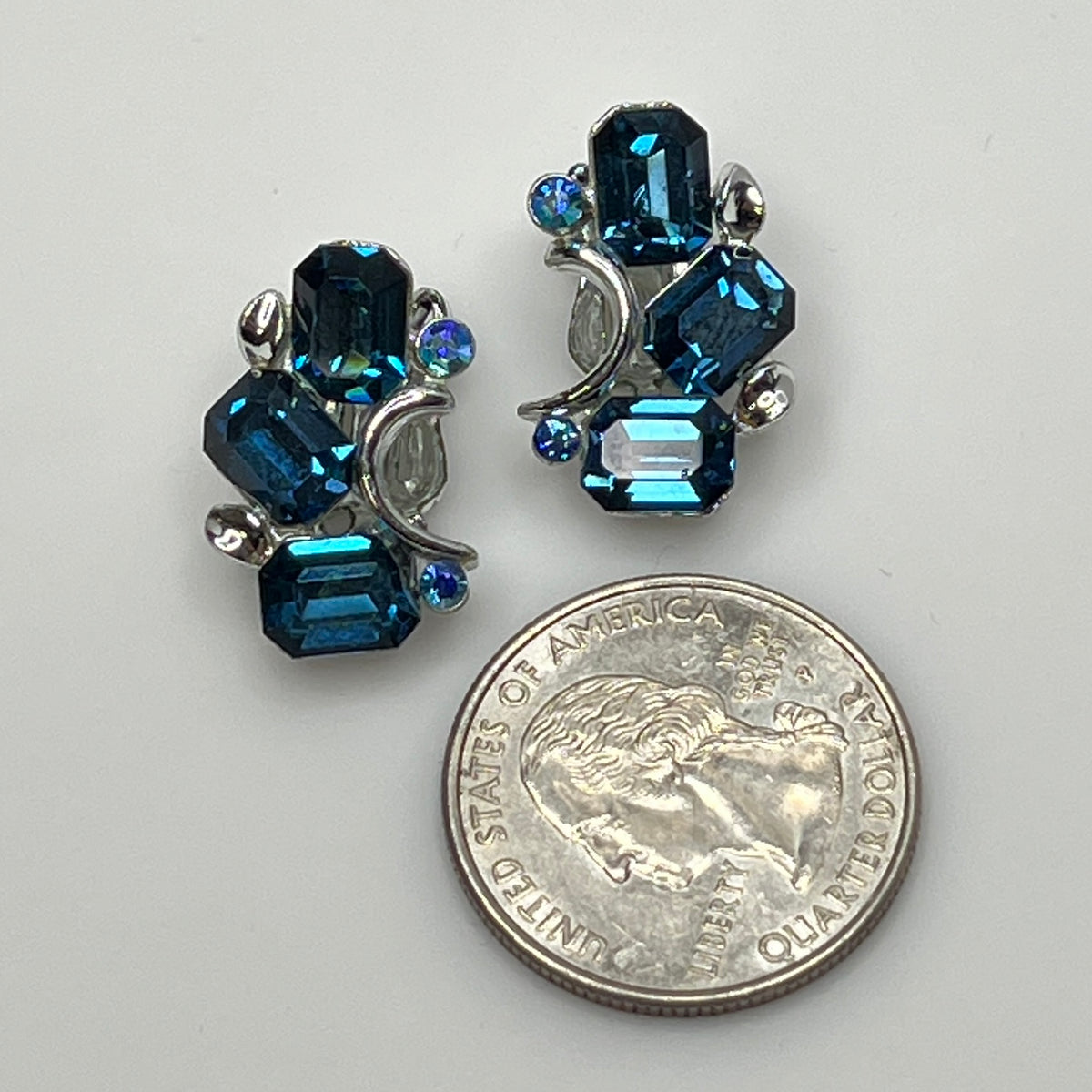 Lisner clip-on earrings with sapphire blue rhinestones and silver-tone setting