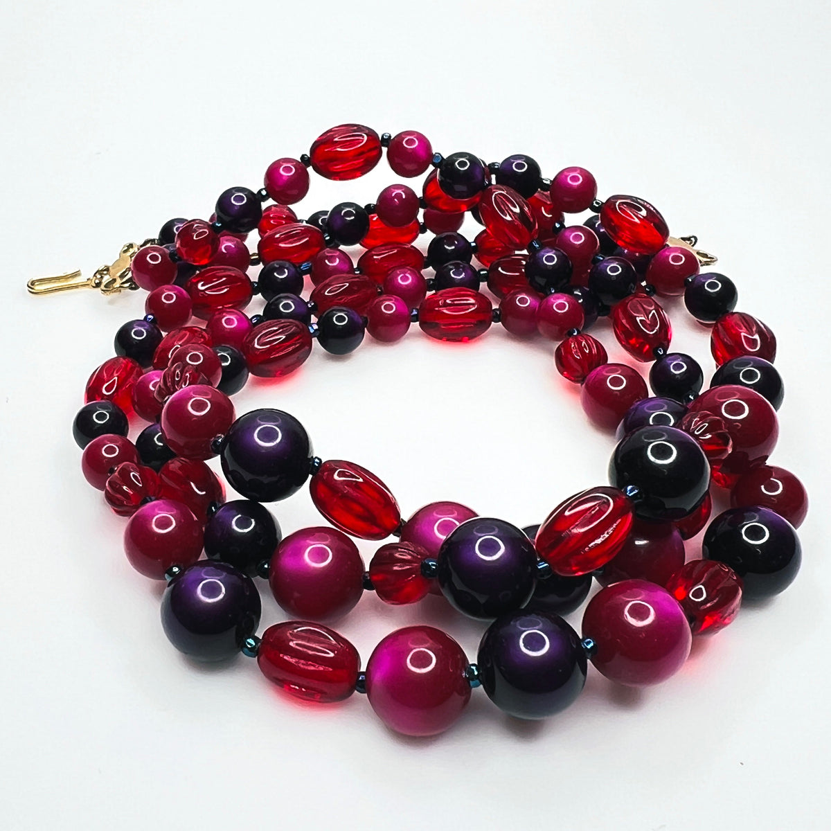 Marvella triple strand necklace gold-tone hook clasp and pink beaded extender chain.