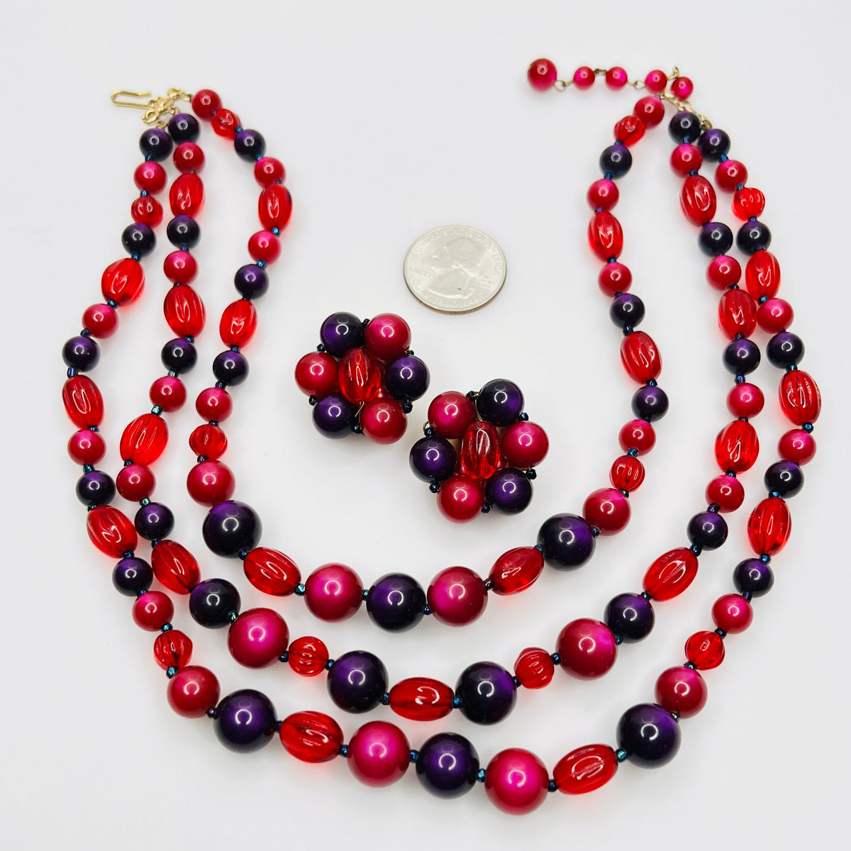 Vintage Marvella colorful triple strand necklace and matching cluster earrings with coin for scale.