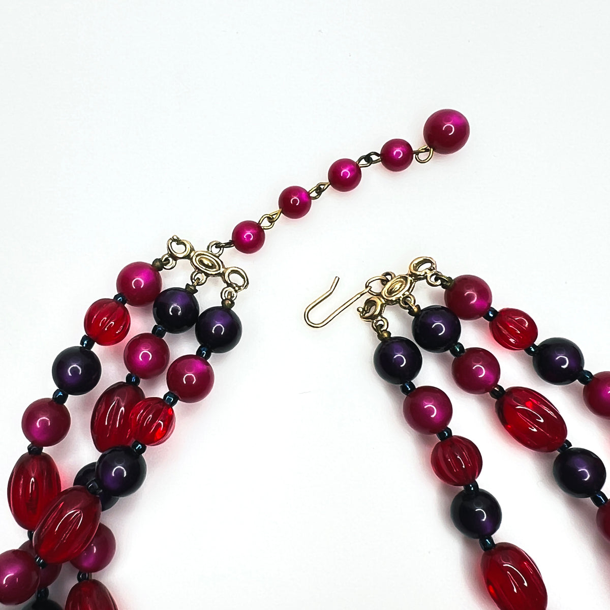 Marvella triple strand necklace gold-tone hook clasp and pink beaded extender chain.