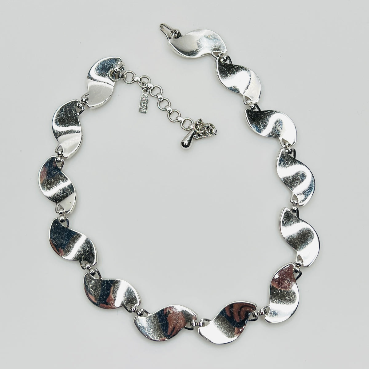 back view Close-up of silver Monet choker with curved leaf links