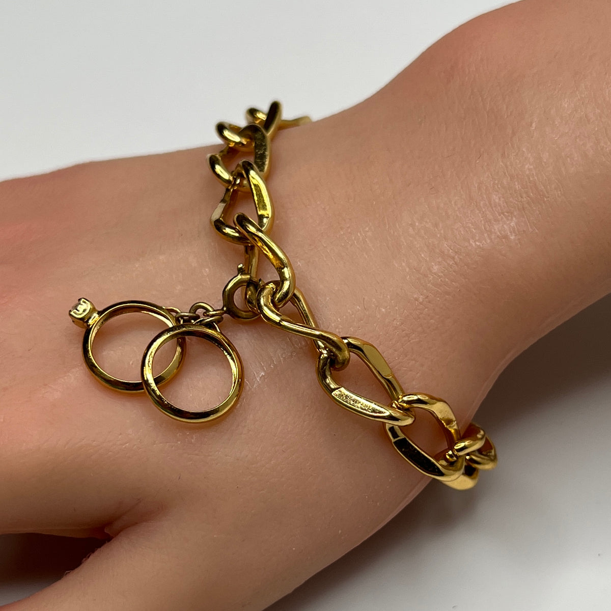 Gold-tone chain bracelet with rhinestone wedding ring charm by Monet