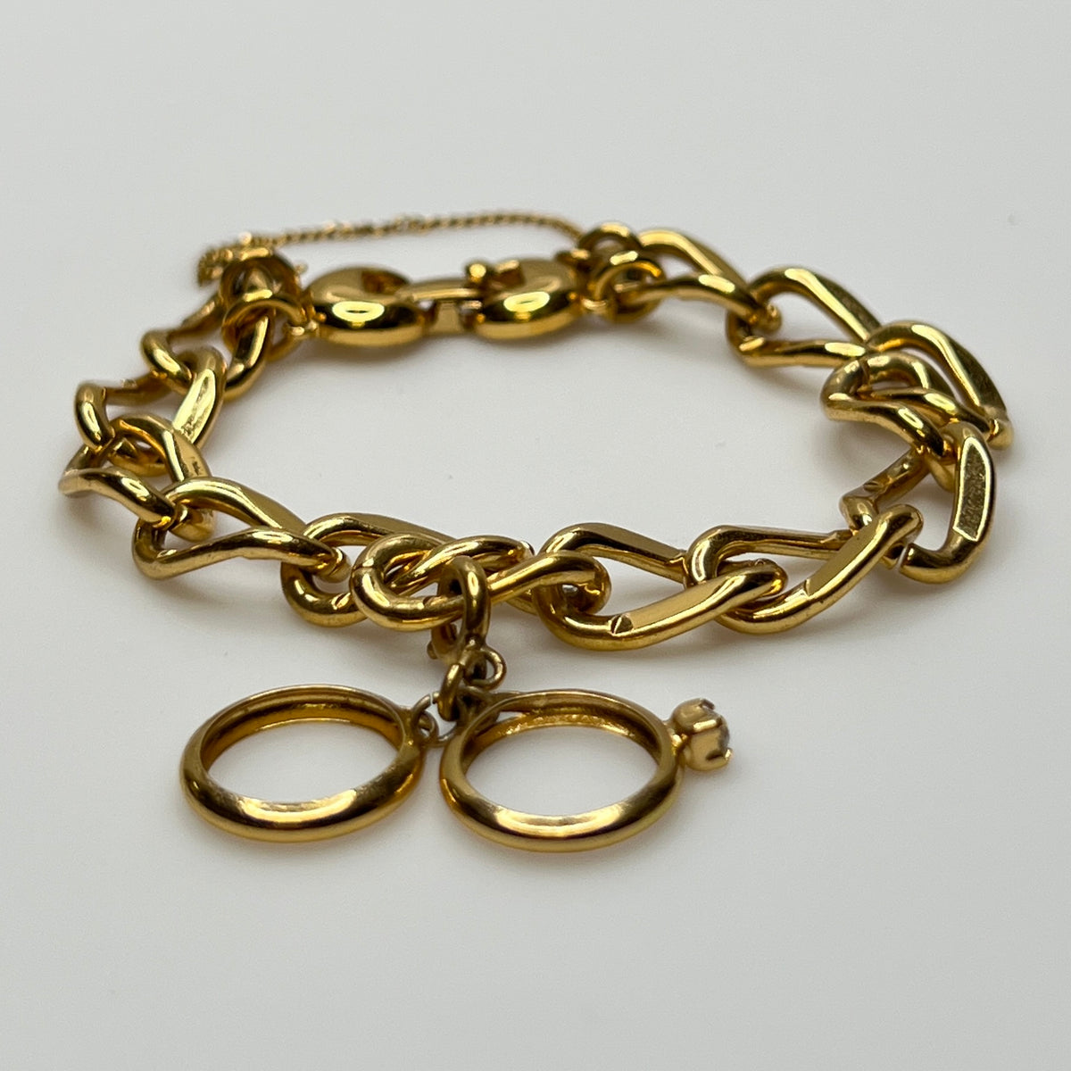 Gold-tone chain bracelet with rhinestone wedding ring charm by Monet