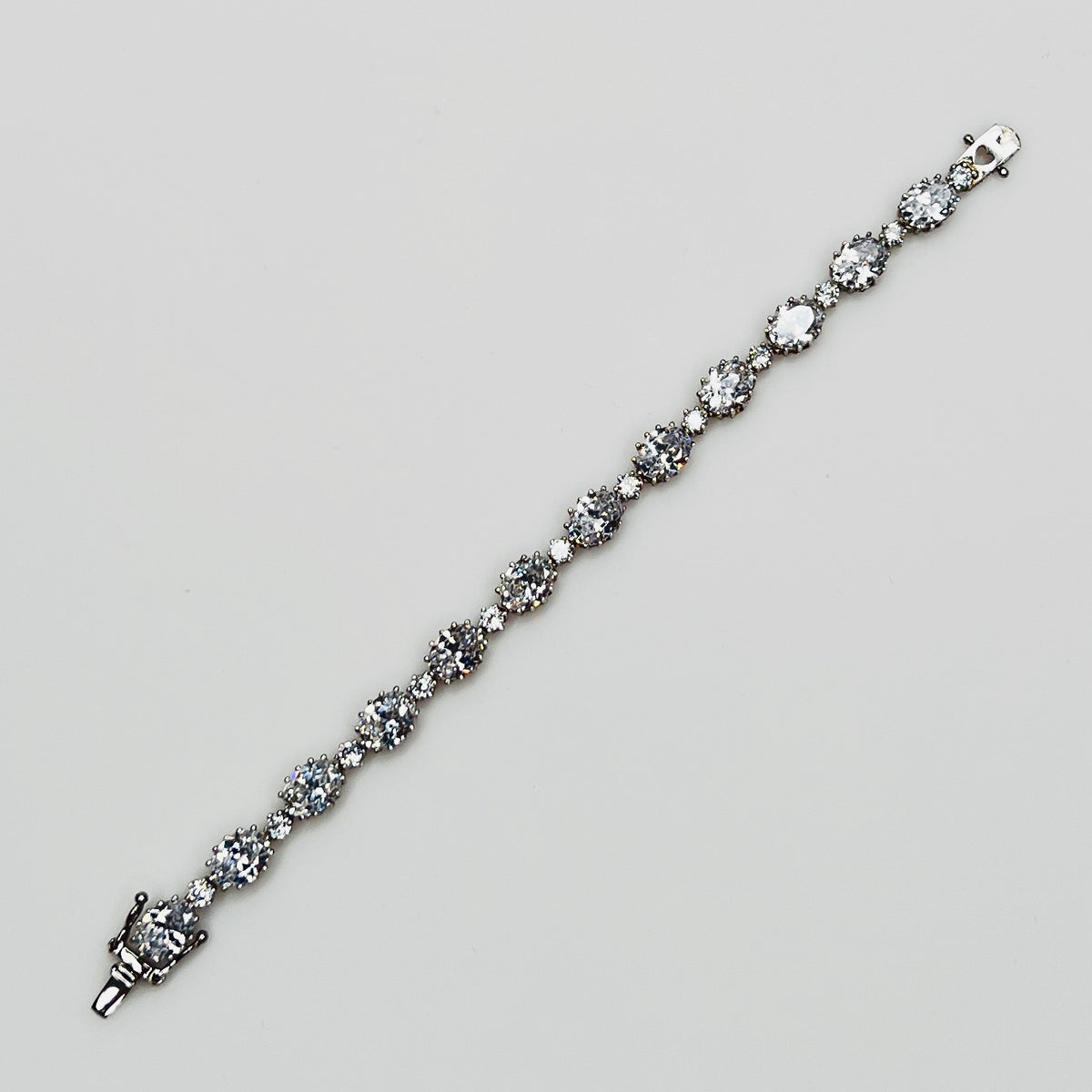 Full view of bracelet with alternating oval and round stones