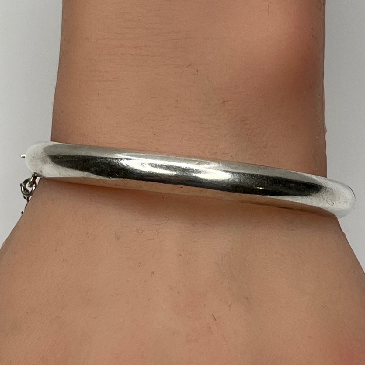Sterling silver vintage bangle bracelet on wrist – smooth polished finish