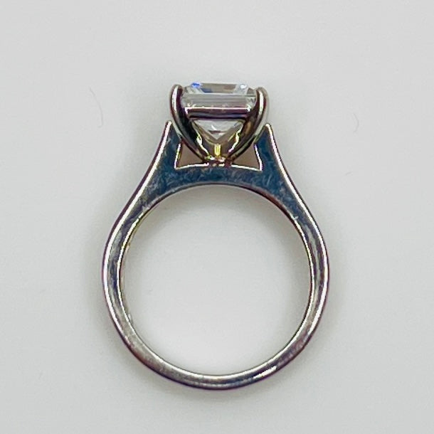 CZ ring with a square-cut gemstone on a light gray background