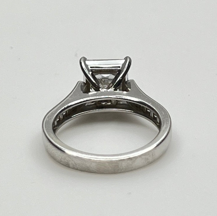 CZ ring with a square-cut gemstone on a light gray background