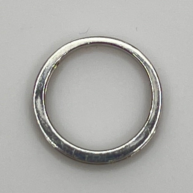 Silver ring with embedded cubic Zirconia on a light gray background