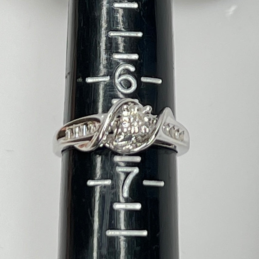 Close-up of diamond bypass ring with round and baguette stones
