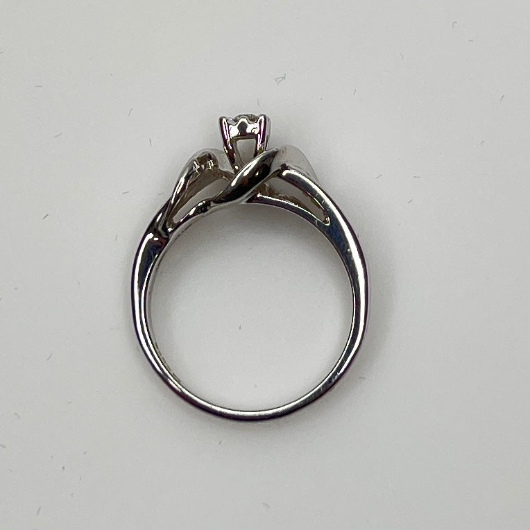Close-up of diamond bypass ring with round and baguette stones